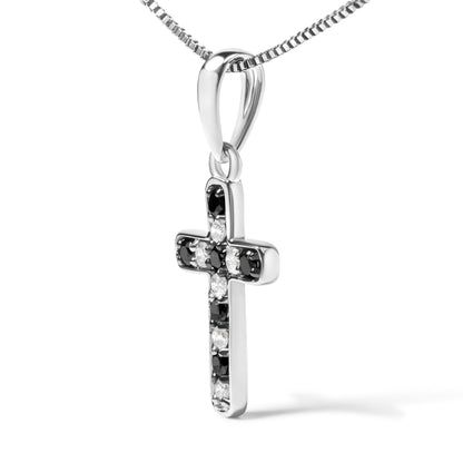 Close-up front angle of a white metal cross pendant necklace with alternating round black and white gemstones in prong settings.