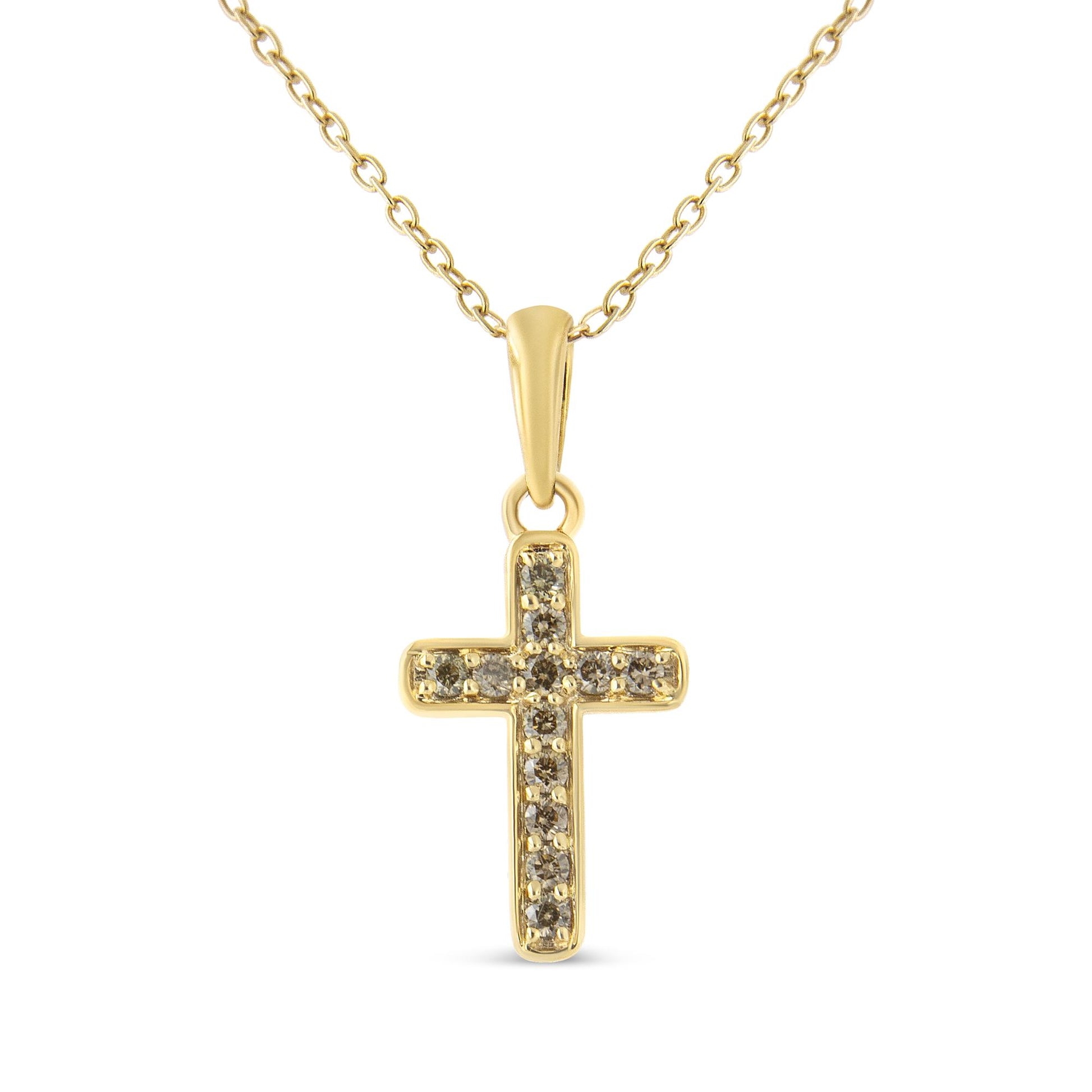 Front-facing shot of a yellow metal cross necklace pendant with multiple round brownish prong-set gemstones.