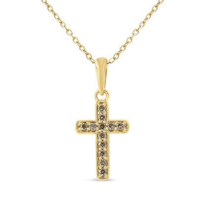 Front-facing shot of a yellow metal cross necklace pendant with multiple round brownish prong-set gemstones.
