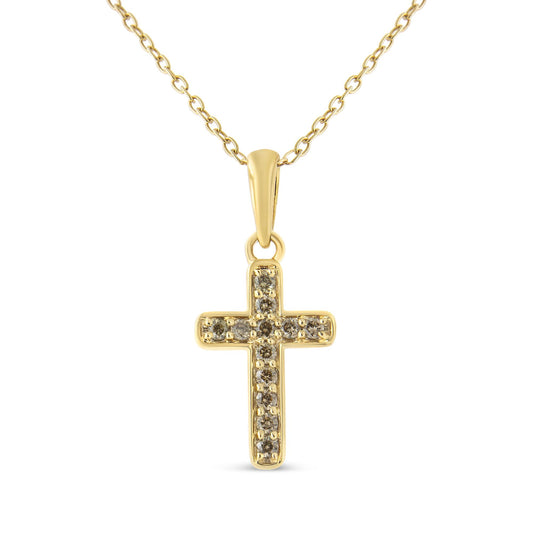 Front-facing shot of a yellow metal cross necklace pendant with multiple round brownish prong-set gemstones.