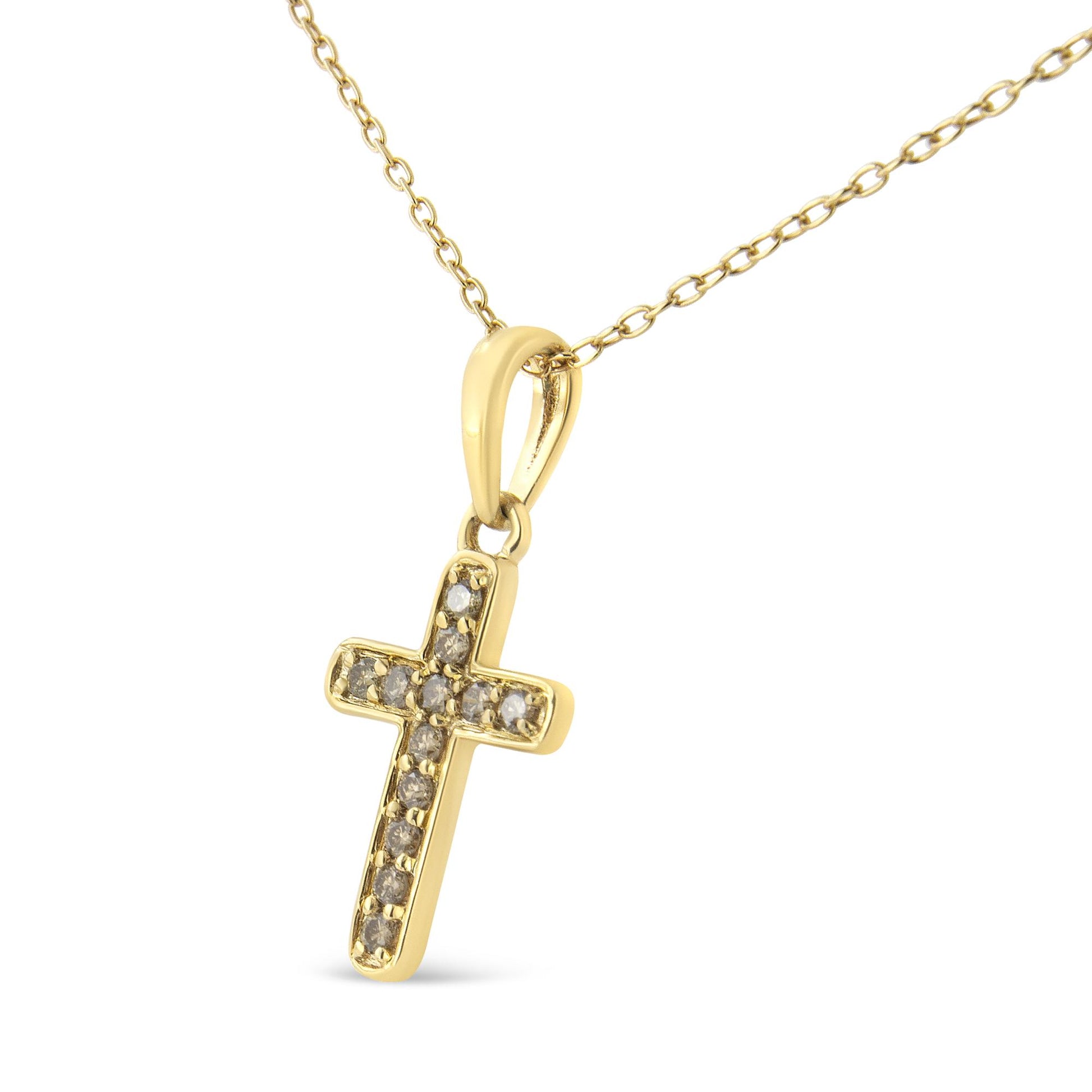 Close-up front angle of a yellow metal cross-shaped pendant necklace accented with round prong-set brownish gemstones.