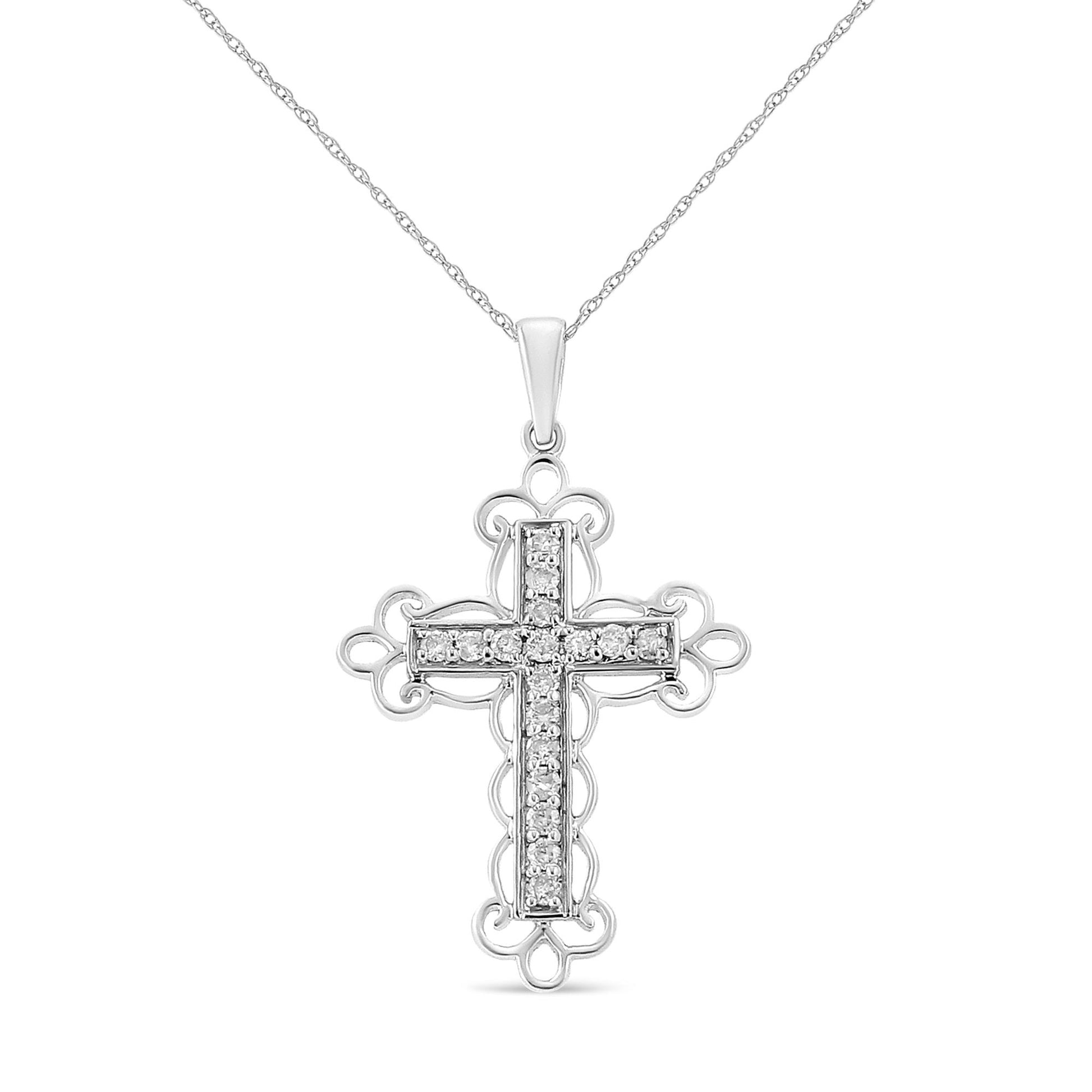 Front angled view of a white metal cross necklace pendant with prong-set round white gemstones on a chain.