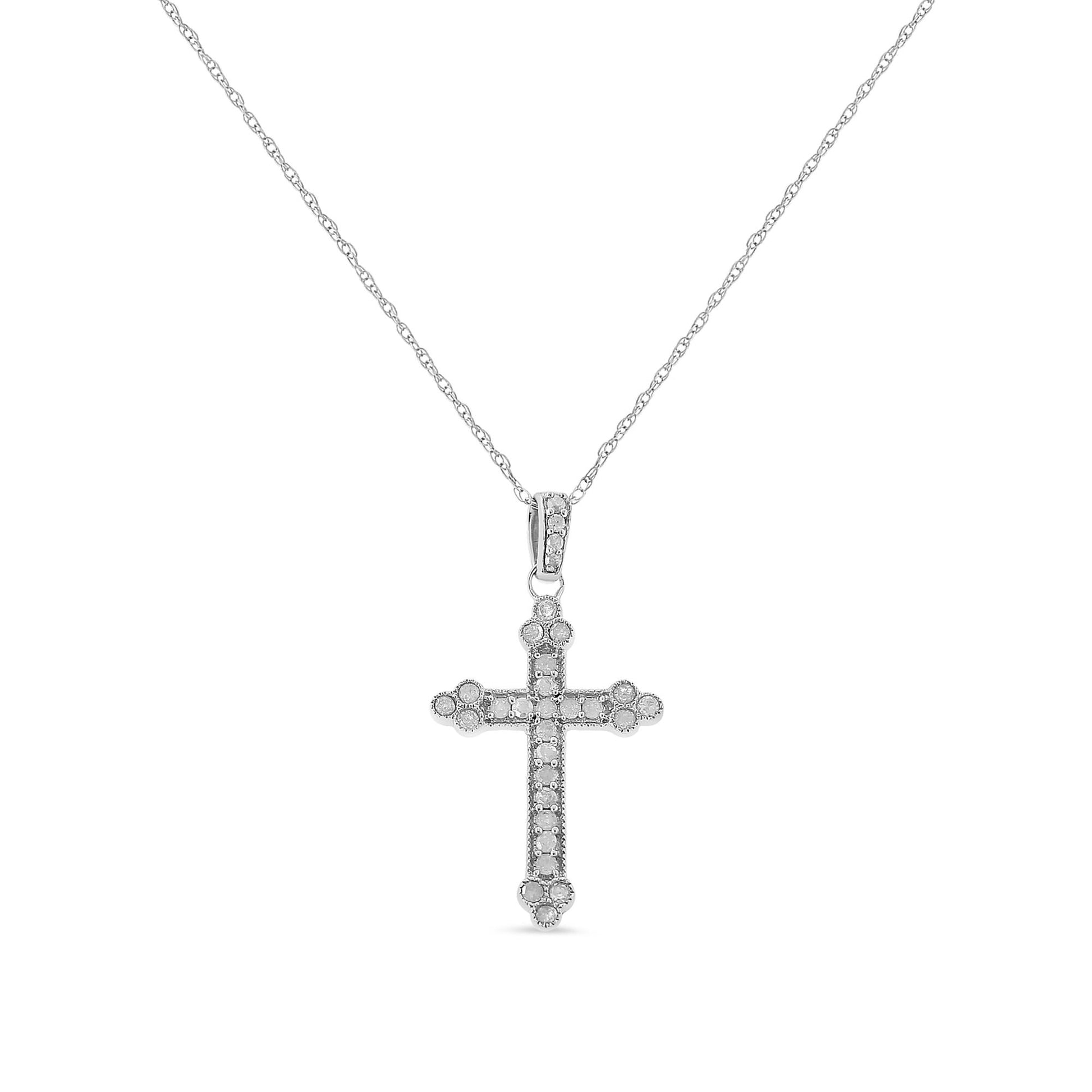 Front view of a white metal cross pendant necklace with round white gemstones in prong settings along the cross and bail.