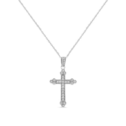 Front view of a white metal cross pendant necklace with round white gemstones in prong settings along the cross and bail.