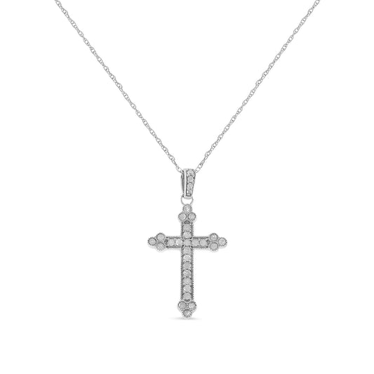 Front view of a white metal cross pendant necklace with round white gemstones in prong settings along the cross and bail.