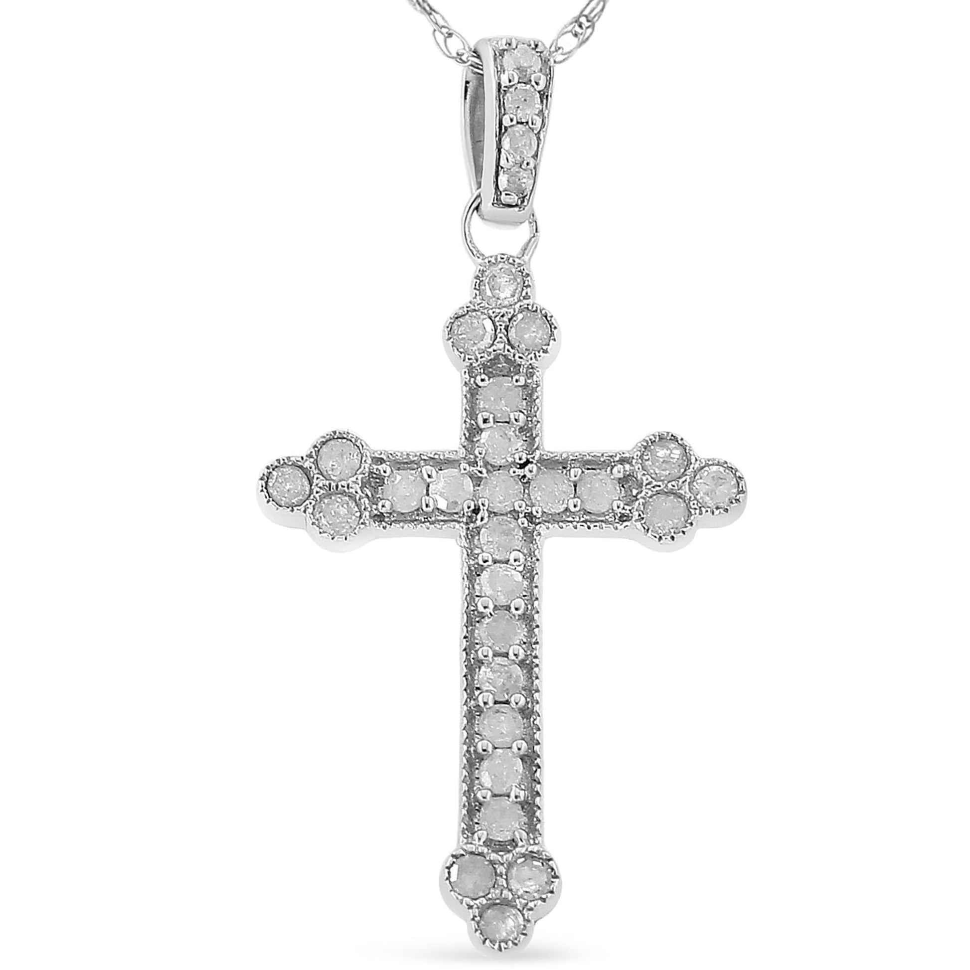 Front view of a white metal cross-shaped necklace pendant adorned with round white gemstones in prong settings.