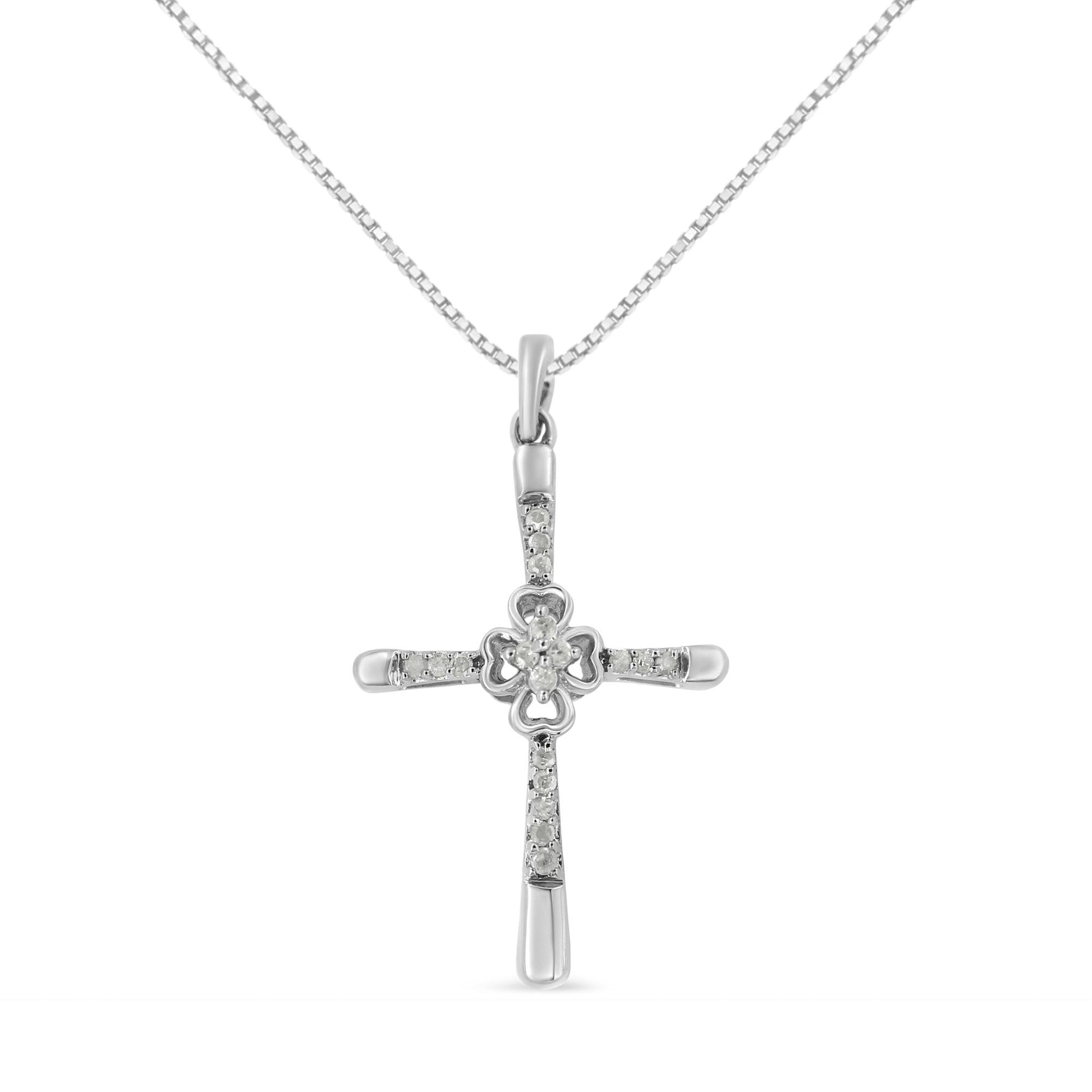Front view of a white metal cross necklace pendant with prong-set round white gemstones.