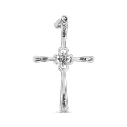Front-facing shot of a white metal cross necklace pendant with round white gemstones in prong settings along the arms and center.