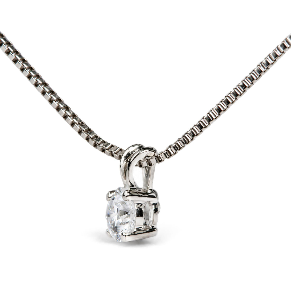 Close-up front angle of a white metal necklace chain with a pendant featuring a single round white gemstone in a 4-prong setting.