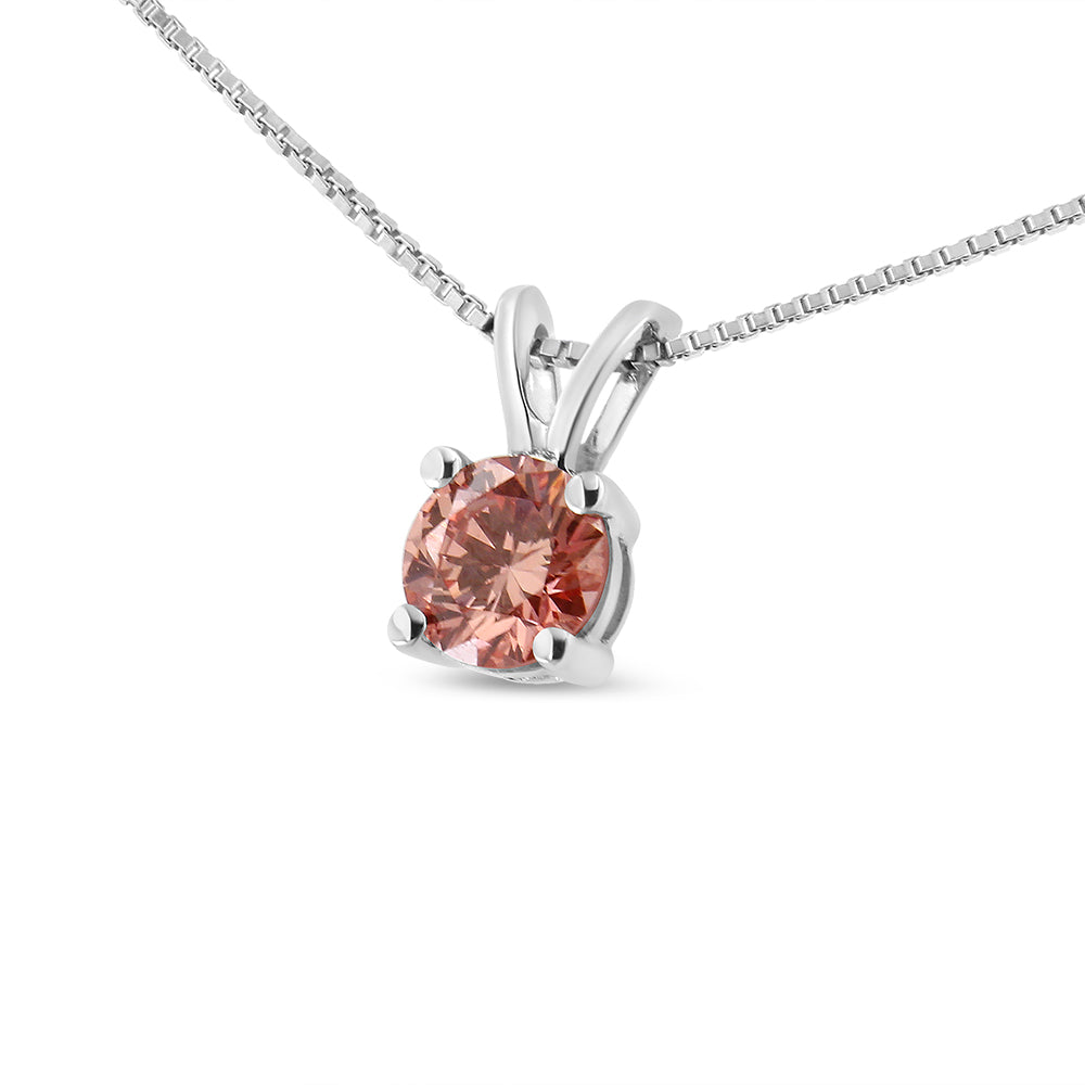 Close-up angled view of a white metal necklace with a round pink gemstone in a prong setting.
