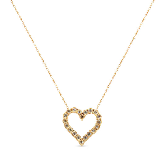 Front view of yellow metal necklace with heart-shaped pendant set with round brownish gemstones.