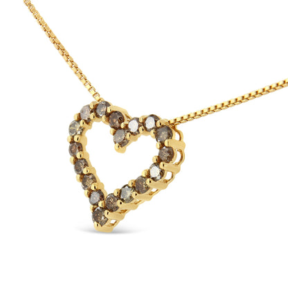 Close-up angled view of a yellow metal heart-shaped necklace pendant set with round prong-set brownish gemstones on a yellow metal chain.
