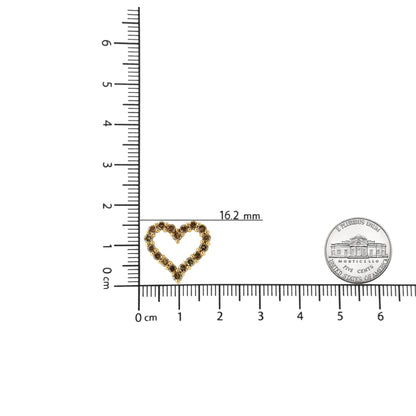 Top view of a yellow metal heart-shaped necklace pendant with round brownish gemstones in prong settings, placed on a ruler for size reference.