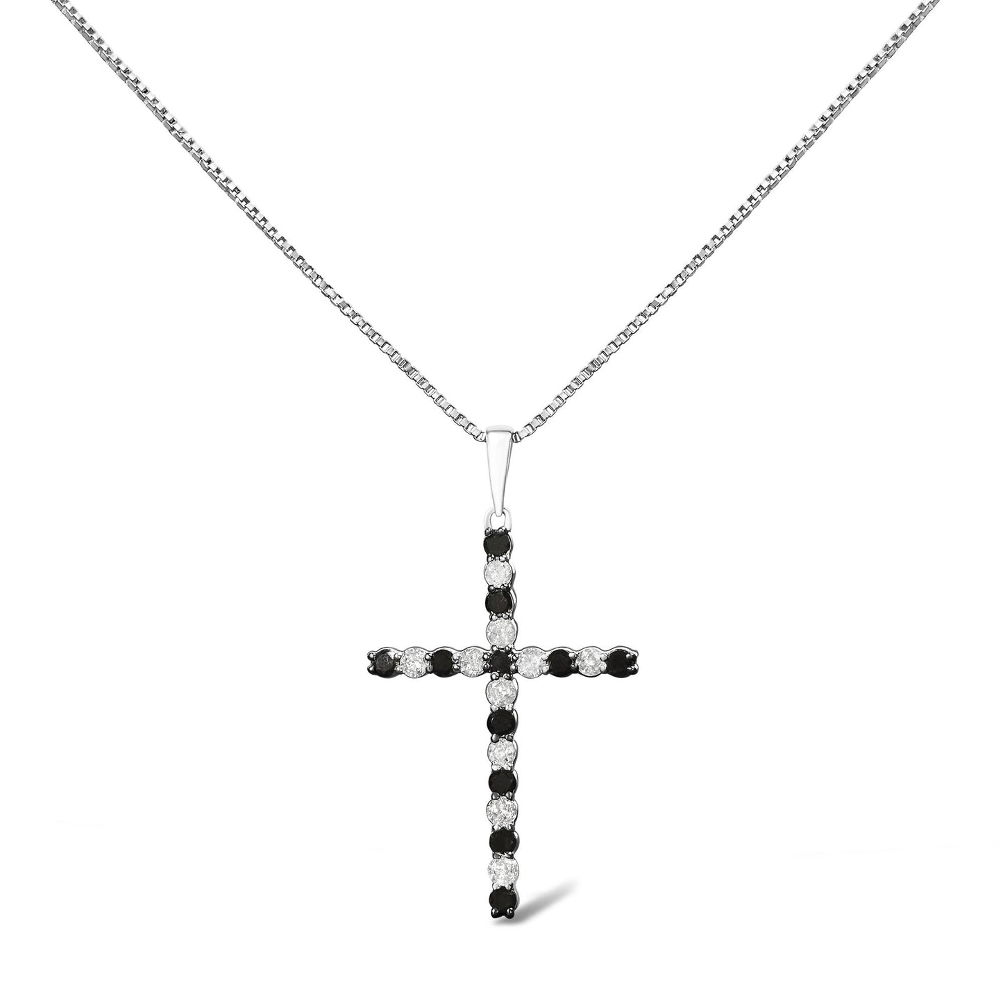 Front-facing shot of a white metal cross-shaped necklace pendant featuring alternating round white and black gemstones in prong settings on a white metal chain.