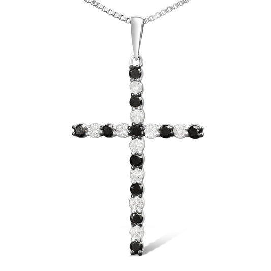 Front-facing image of a white metal cross necklace pendant set with alternating round white and black gemstones in prong settings.