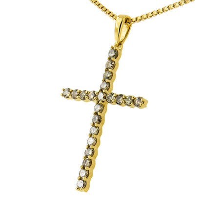 Close-up front angle of a yellow metal cross-shaped necklace pendant with round prong-set brownish gemstones.