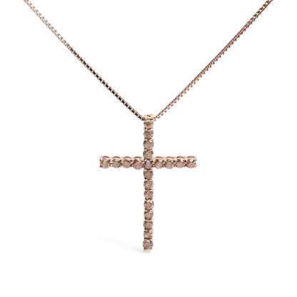 Front-facing shot of a rose-colored metal cross necklace pendant set with round champagne-colored gemstones in prong settings.