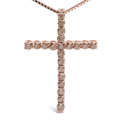 Front view of a rose metal cross necklace pendant with round champagne-colored gemstones in prong settings.