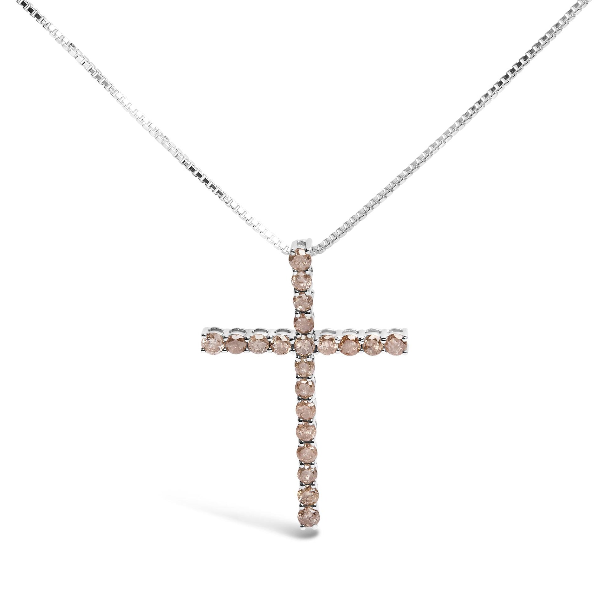 Front angle of a white metal necklace with a cross-shaped pendant set with round prong-set champagne-colored gemstones.