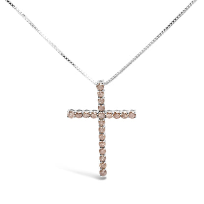 Front angle of a white metal necklace with a cross-shaped pendant set with round prong-set champagne-colored gemstones.