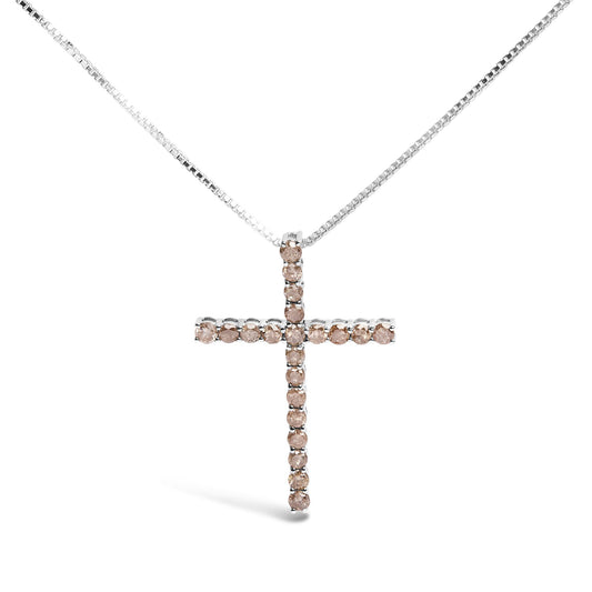 Front angle of a white metal necklace with a cross-shaped pendant set with round prong-set champagne-colored gemstones.