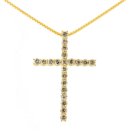 Front-facing view of a yellow metal cross-shaped necklace pendant set with round brownish prong-set gemstones along the vertical and horizontal bars.