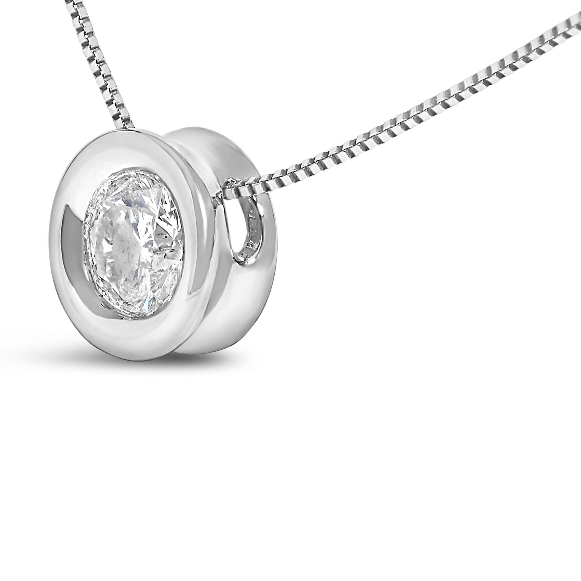 Close-up front angle of a white necklace pendant with a single round white gemstone in a bezel setting on a box chain.