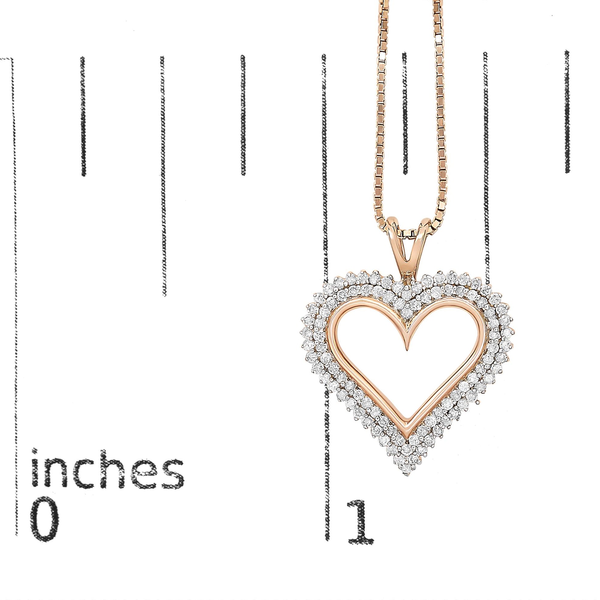 Close-up front view of a rose metal heart-shaped necklace pendant with two rows of round white gemstones in prong settings, displayed on a ruler for size reference.