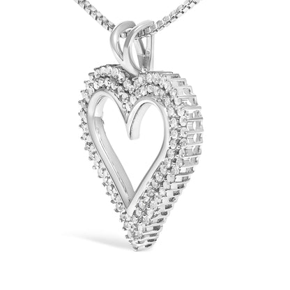 Close-up angled view of a white metal heart-shaped necklace pendant with two rows of round white gemstones in prong settings surrounding the open center, suspended from a matching chain.