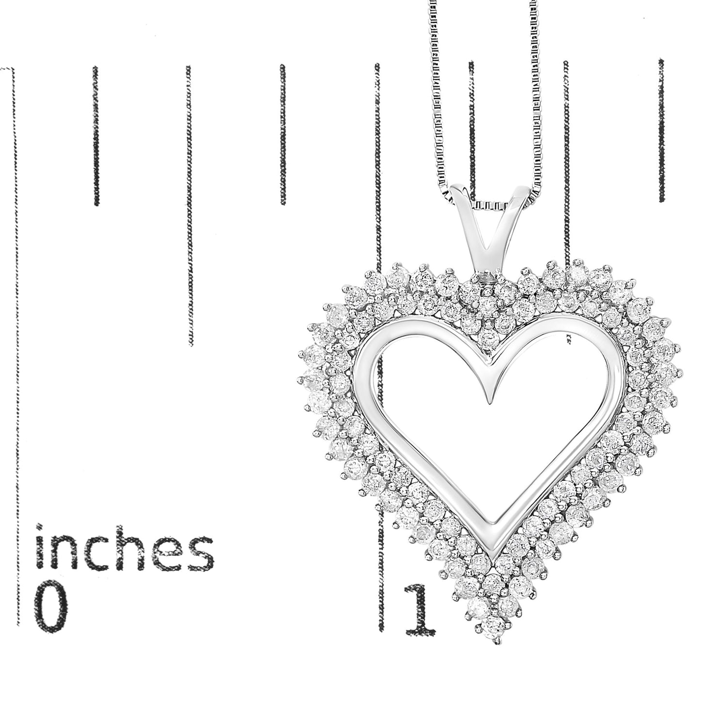 Close-up front view of a white metal heart-shaped necklace pendant with two rows of round white gemstones in prong settings, shown on a ruler for size reference.