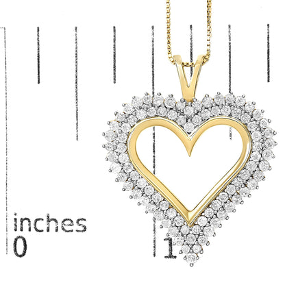 Close-up front view of a yellow metal heart-shaped necklace pendant with white round gemstones in prong settings around the border, shown on a ruler for size reference.