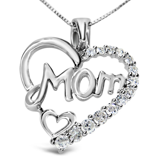 Close-up front angle of a white metal necklace pendant shaped as a heart with the word 'Mom' inside and accented with round white gemstones along one side and a small heart outline at the bottom.