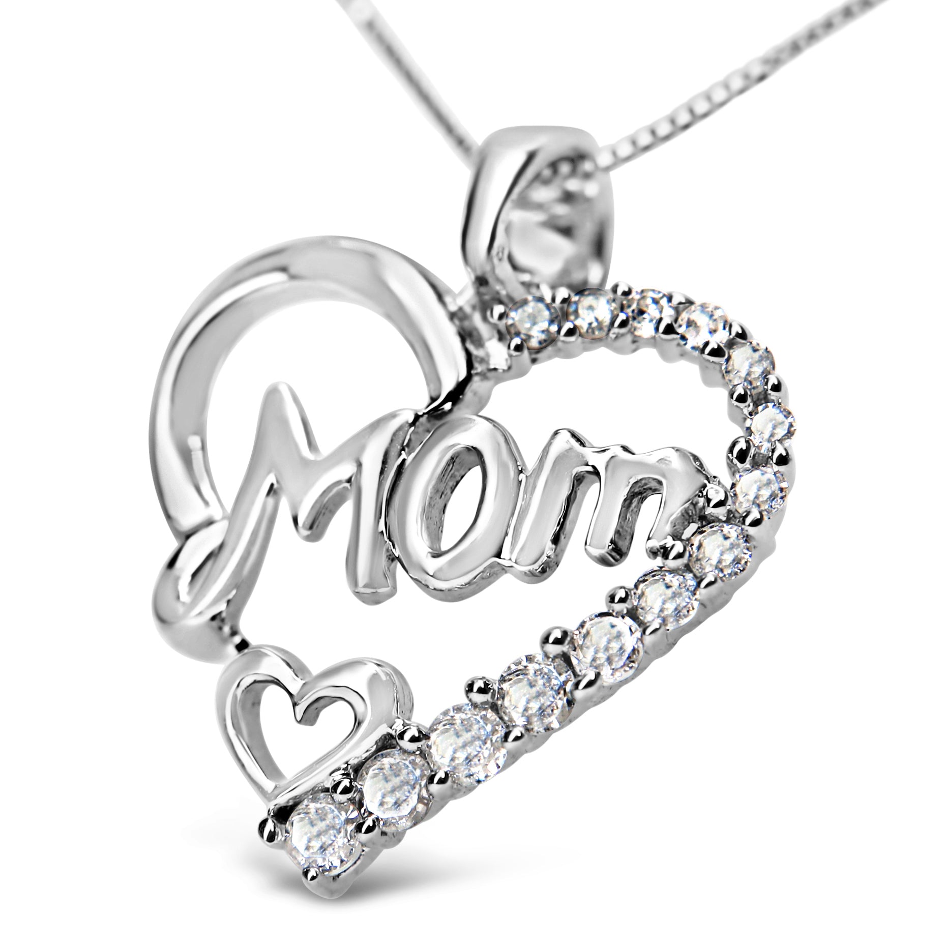 Close-up angled view of a white metal necklace pendant shaped like a heart with the word 'Mom' in script inside, accented with prong-set round white gemstones along one side and a small heart near the bottom.