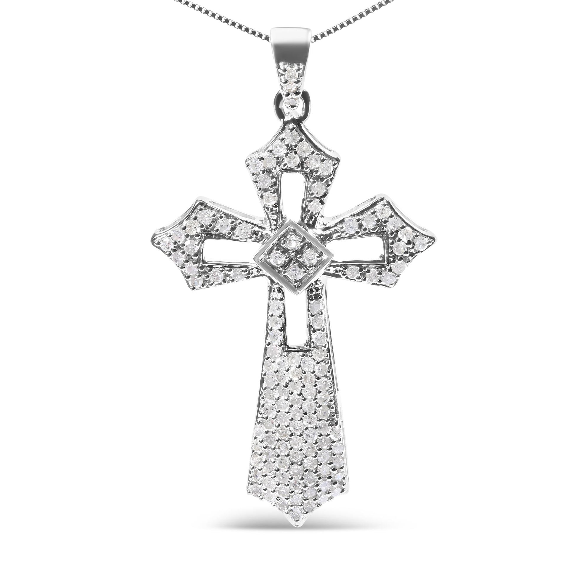 Front-facing shot of a white metal cross-shaped necklace pendant adorned with multiple round white gemstones in prong settings.