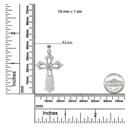 Front view of a white metal cross-shaped necklace pendant with round white gemstones in prong settings, shown on a ruler and next to a coin for size reference.
