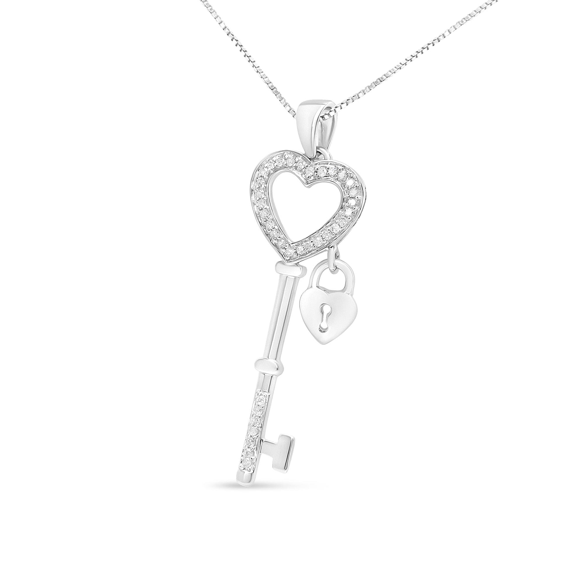 Front-facing shot of a white metal necklace pendant shaped like a key with a heart outline adorned with white gemstones and a small heart-shaped lock charm hanging inside the key's top.