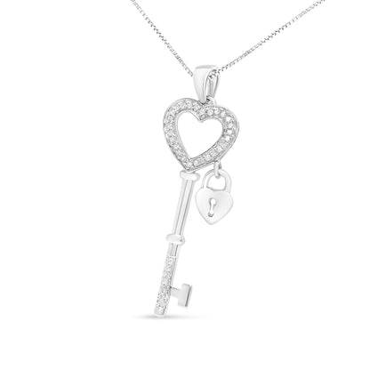 Front-facing shot of a white metal necklace pendant shaped like a key with a heart outline adorned with white gemstones and a small heart-shaped lock charm hanging inside the key's top.