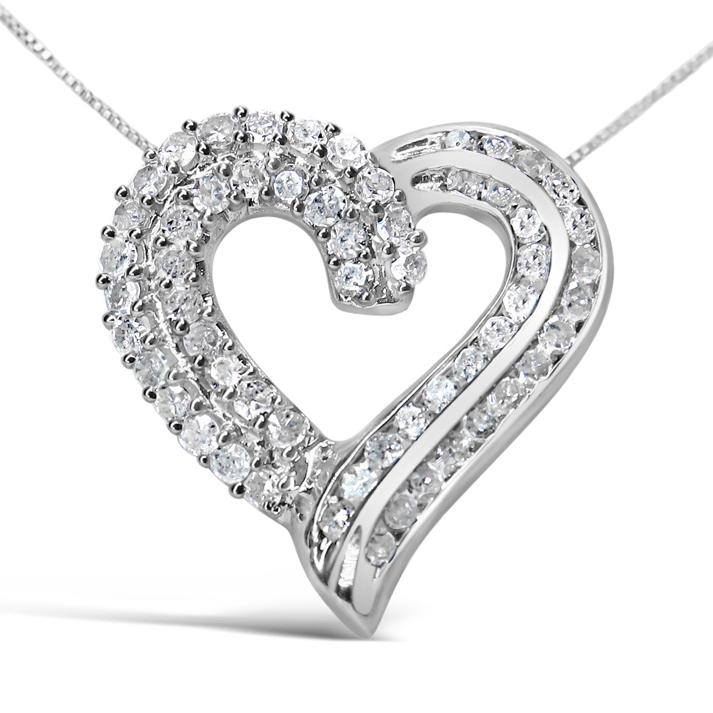 Close-up front view of a white metal heart-shaped necklace pendant with two rows of round white gemstones in prong settings on one side and two rows of round white gemstones in channel settings on the other side.