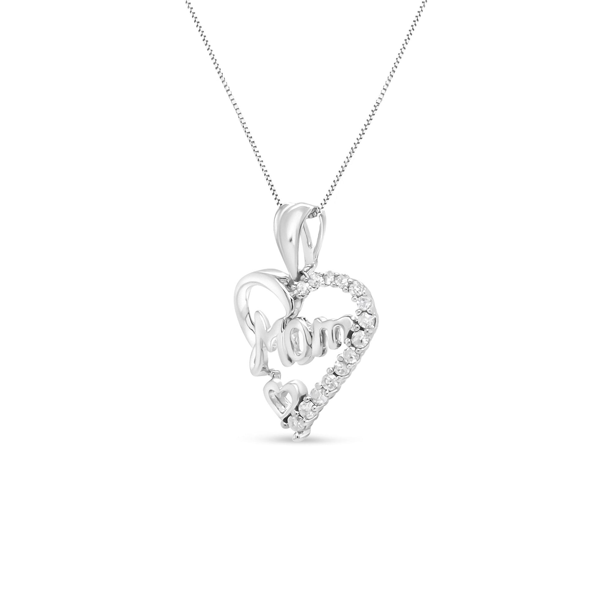 Front view of a white metal heart-shaped necklace pendant with the word 'Mom' inside and white gemstones outlining part of the heart.