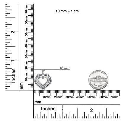 White heart-shaped necklace pendant with two rows of white gemstones in prong and channel settings, shown on a ruler and scale for size reference, front-facing angle.
