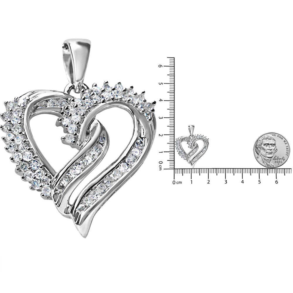 Close-up front angle of a white metal heart-shaped necklace pendant with white round prong-set gemstones on one side and channel-set gemstones on the other side, placed next to a ruler and coin for size reference.