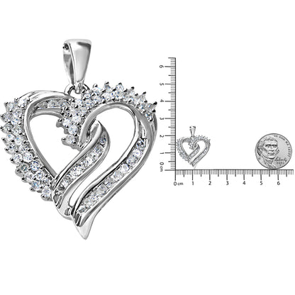 Close-up front angle of a white metal heart-shaped necklace pendant with white round prong-set gemstones on one side and channel-set gemstones on the other side, placed next to a ruler and coin for size reference.