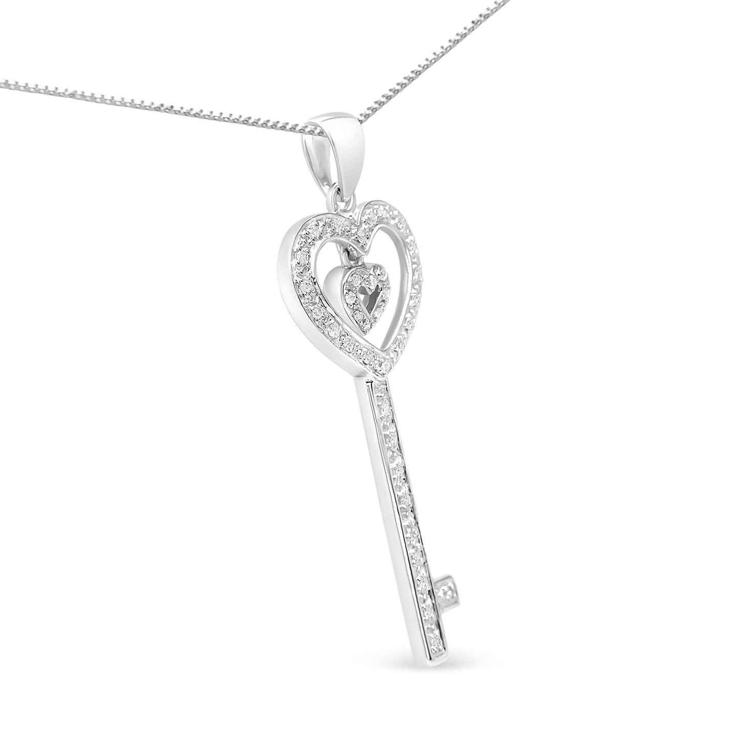White metal necklace with heart-shaped key pendant adorned with round white gemstones in prong settings, shown in a close-up side angle.