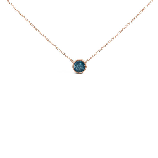 Close-up front view of a rose-colored necklace with a round blue gemstone set in a bezel setting, shown on a white background.
