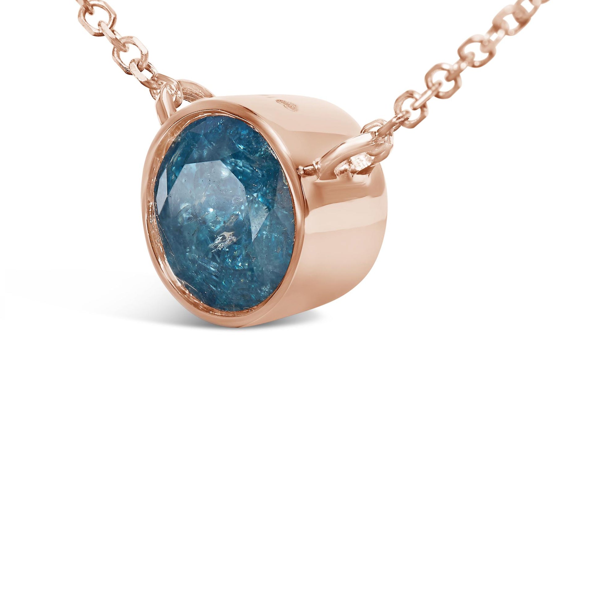 Close-up front angle of a rose metal necklace featuring a round bezel-set blue gemstone pendant.