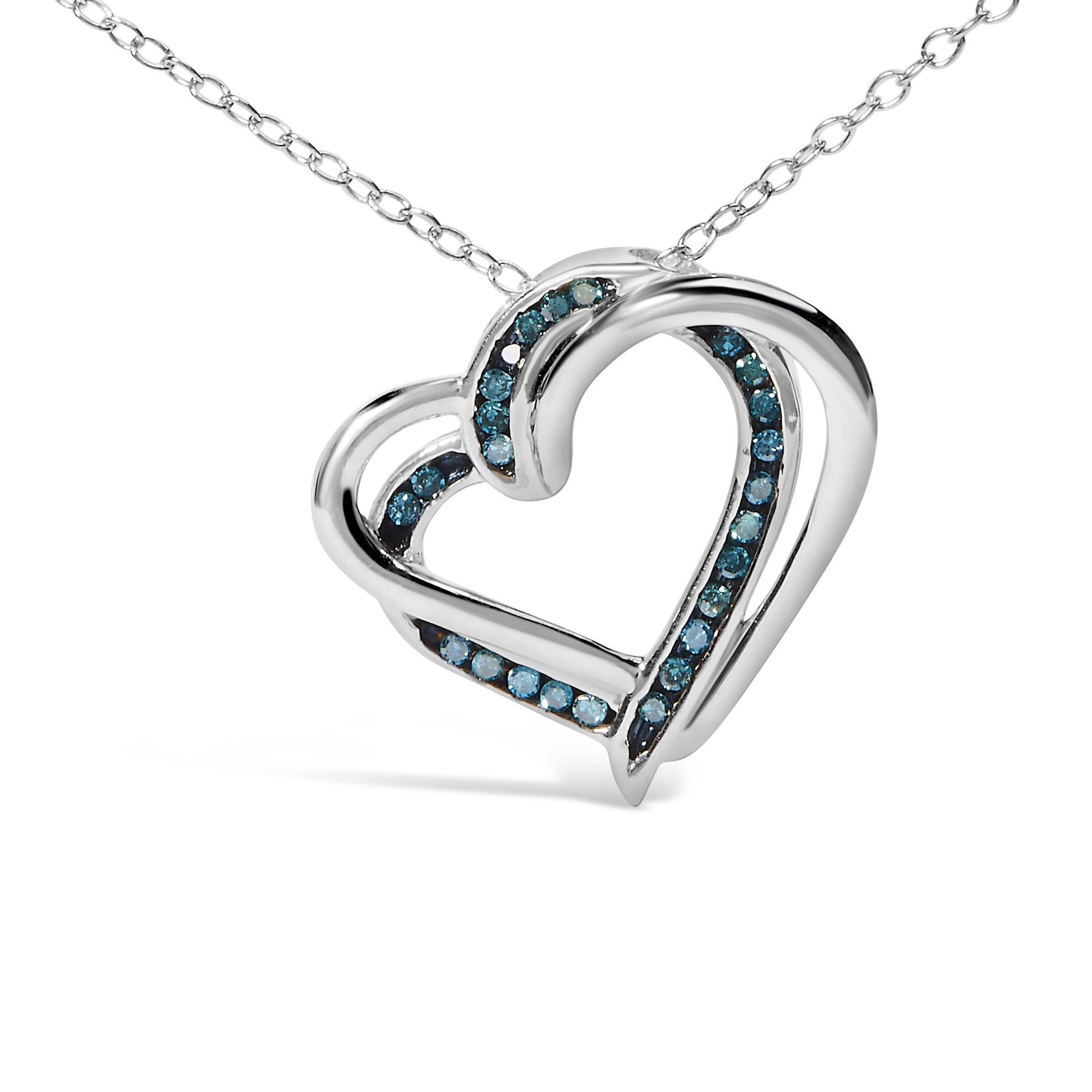 Close-up front angle of a white metal heart-shaped necklace pendant with round blue gemstones set in a channel along the inner curves.