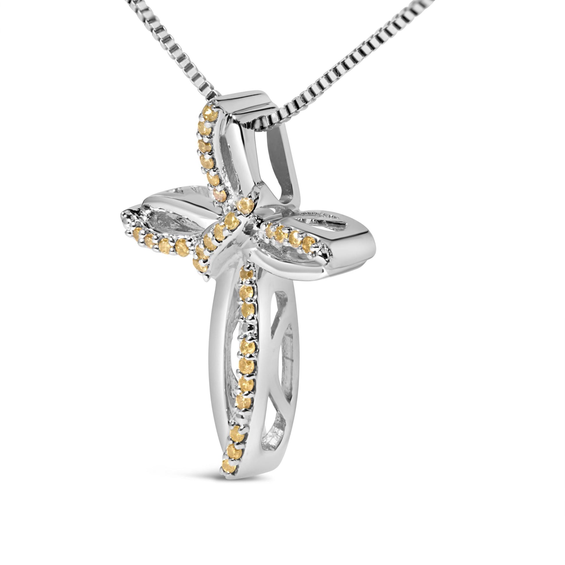 Close-up front angle of a white metal necklace pendant shaped like a cross, adorned with small round yellow gemstones in prong settings along its edges.