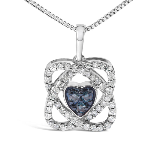 Front-facing image of a white metal necklace with a pendant featuring a heart shape center with blue gemstones surrounded by a square frame encrusted with white gemstones in prong settings.