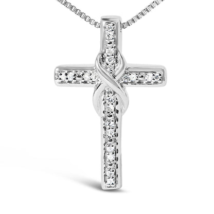 Front angled close-up of a white metal cross necklace pendant featuring round white gemstones in prong settings.