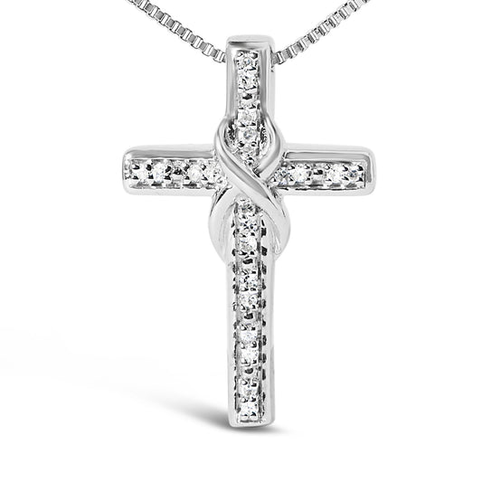 Front angled close-up of a white metal cross necklace pendant featuring round white gemstones in prong settings.
